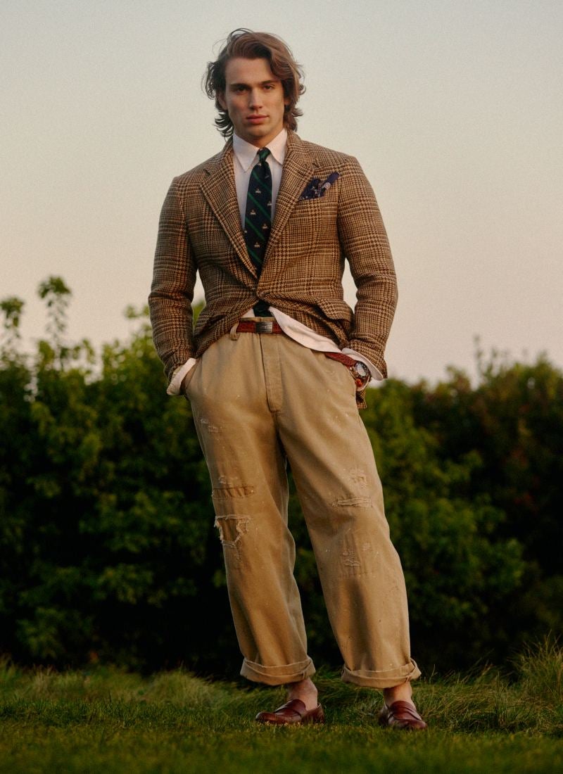 Man wears tweed sport coat and chinos.