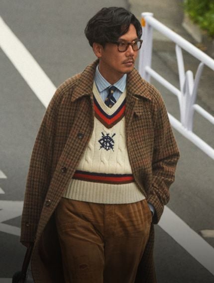 Man wears a brown sport coat over a Fair Isle sweater.