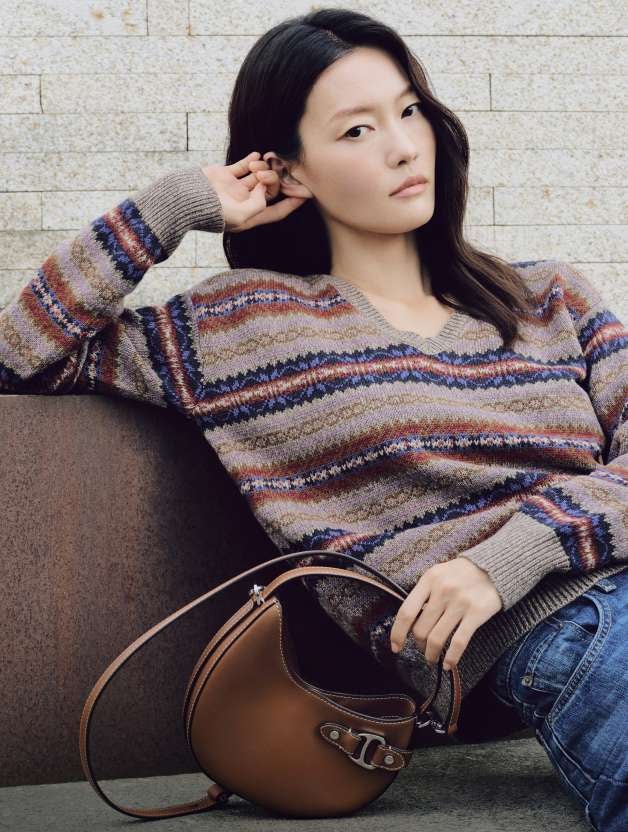 Man wears a brown sport coat over a Fair Isle sweater.