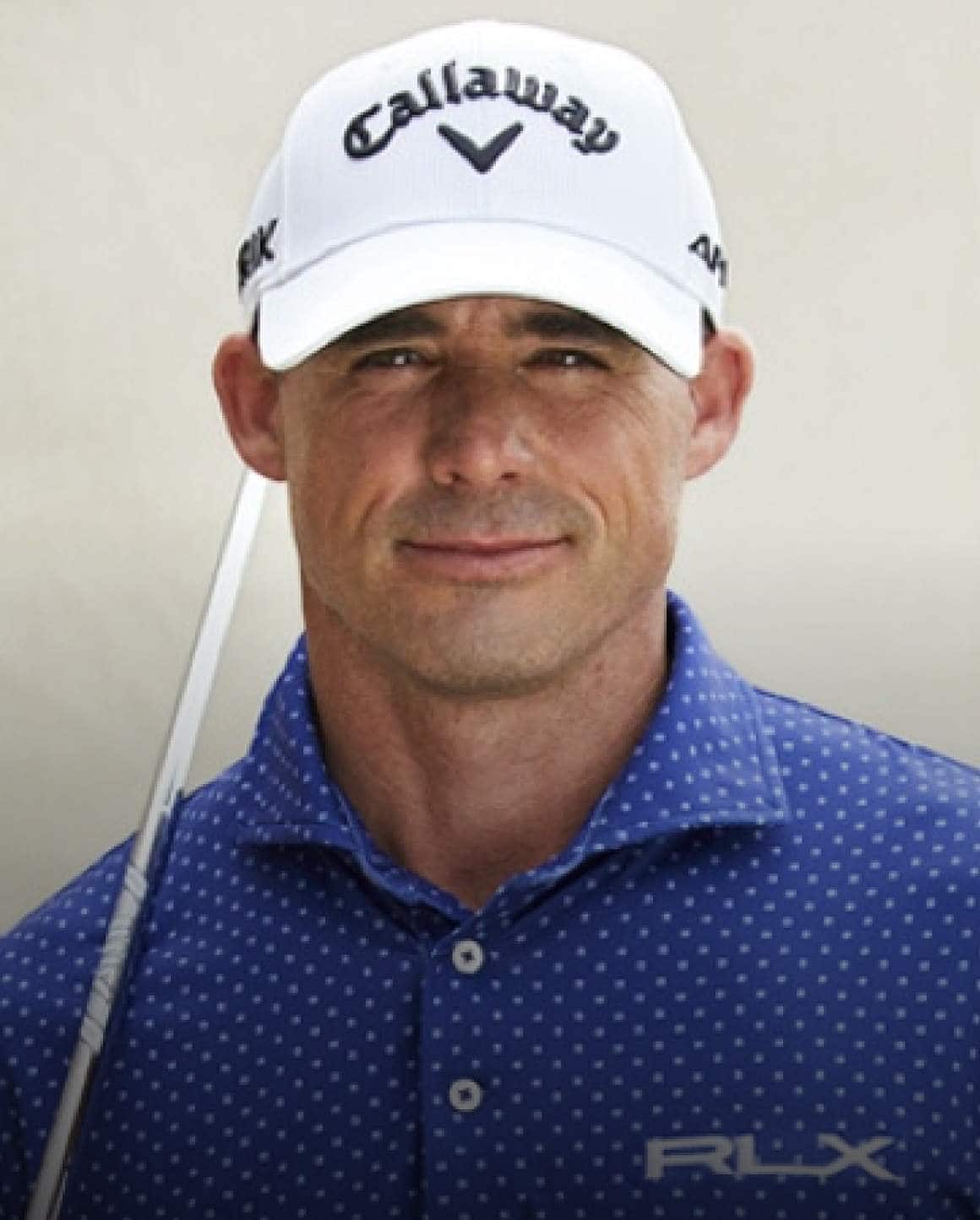 Photo of Jonathan Byrd in white call bap and blue polka-dot Polo shirt.
