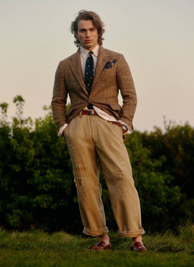 Man wears tweed sport coat and chinos.